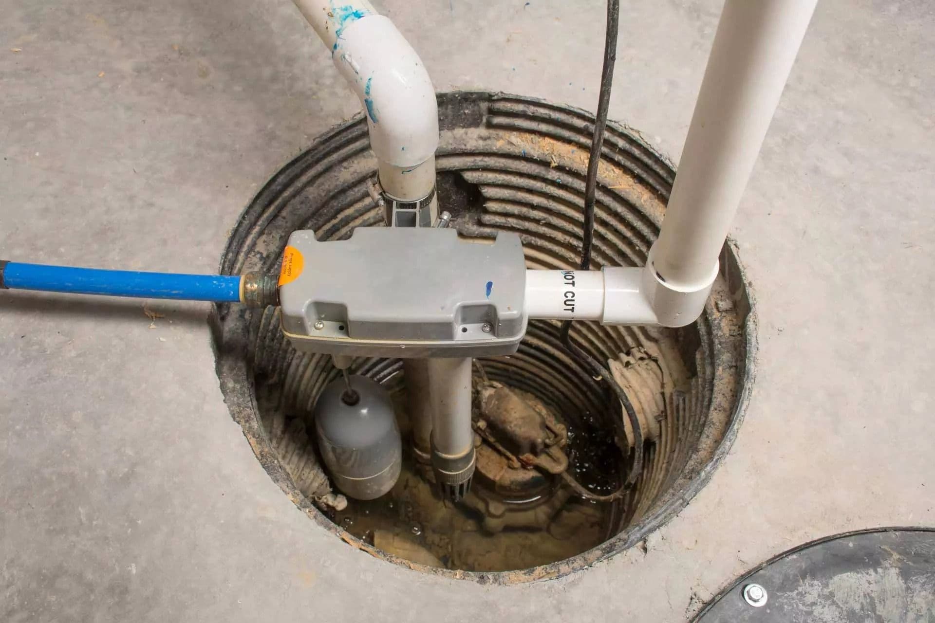 Sump pump installed in a basement sump pit with discharge piping and float switch, designed to automatically remove groundwater and help prevent basement flooding.