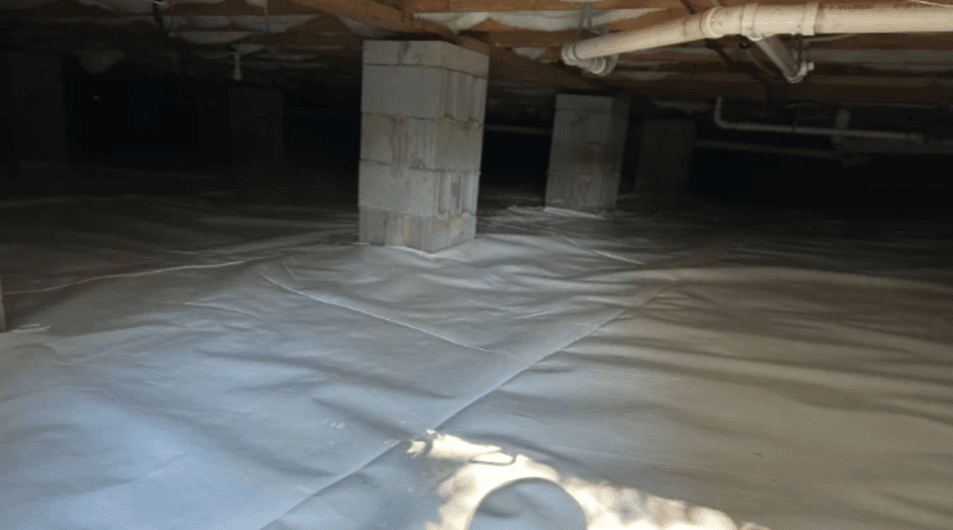 Dim crawlspace with plastic vapor barrier flooring, concrete support pillars, exposed pipes, and low wooden ceiling; eerie, utilitarian mood.